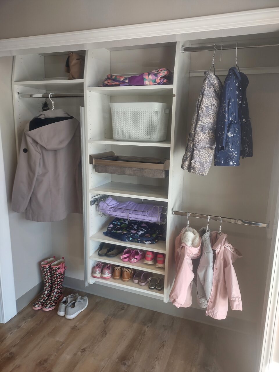 reach-in closet with metal rods and shelves