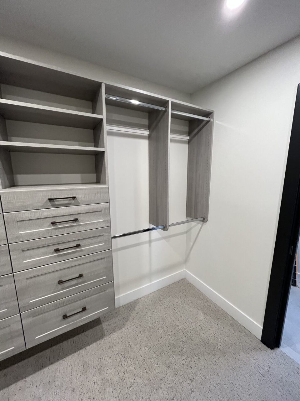 walk in closet with metal rods, shelves and drawers