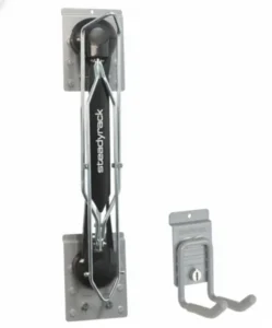 Wall-mounted bike storage rack with a black and silver frame labeled "Steadyrack," next to a gray wall hook with a lockable clasp. Closet Concepts of Grand Rapids