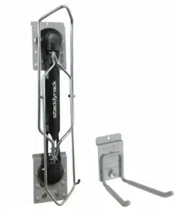 Two metal wall-mounted storage racks: one vertical bike rack with a locking arm and one dual-arm utility hook. Closet Concepts of Grand Rapids