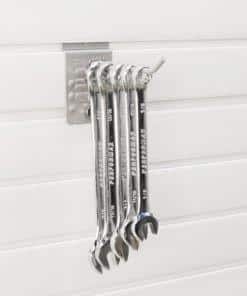 Five metal wrenches are hanging on a wall-mounted holder against a white panel background. Closet Concepts of Grand Rapids
