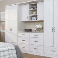 arctic white closet with cabinets, shelves, drawers and countertops